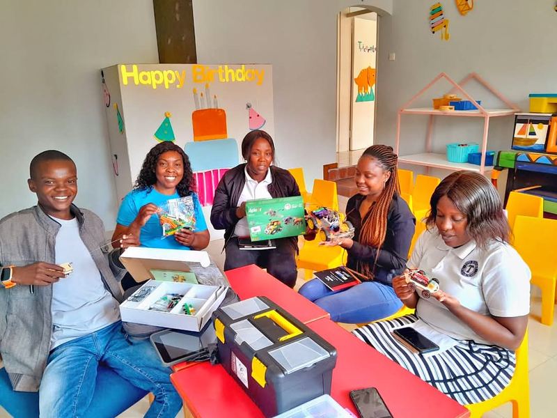 Educators unboxing and testing robotics kits during a training session