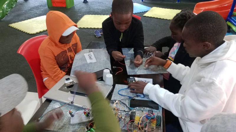 Students building a circuit together at a club session